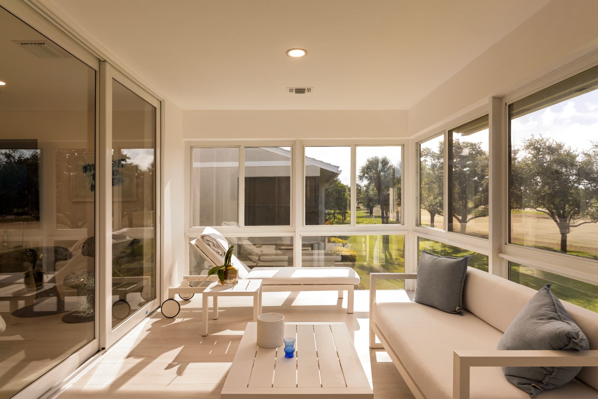 Sunlit sunroom with wide windows, photographed by AV Media Collective